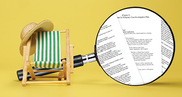 Beach chair and hat in front of large magnify glass