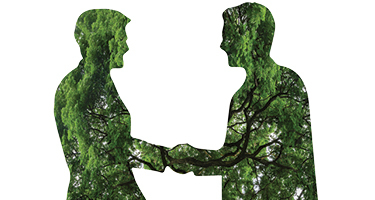 Trees fill two silhouettes shaking hands