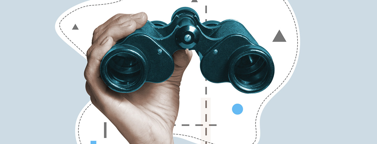 Hand holding binoculars scouts out law firms 