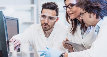 Scientists' discuss their expert witness findings on a computer in a lab