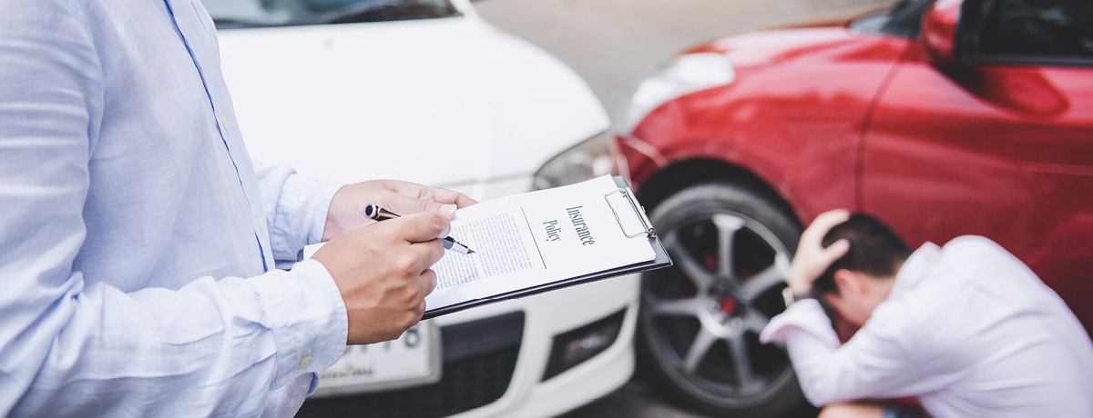 Figure with clipboard assesses the scene of an accident