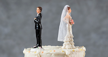 Bride and groom figurines on top of a wedding cake