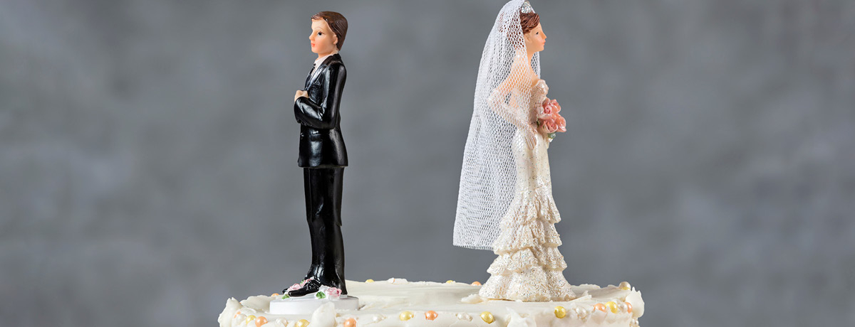 Bride and groom figurines on top of a wedding cake