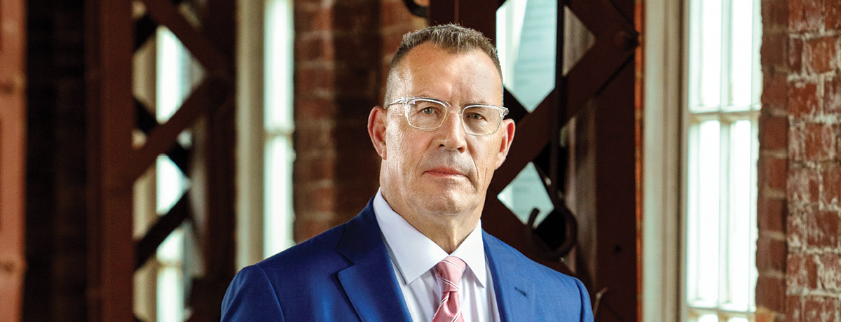 Suited man with glasses poses for professional headshot
