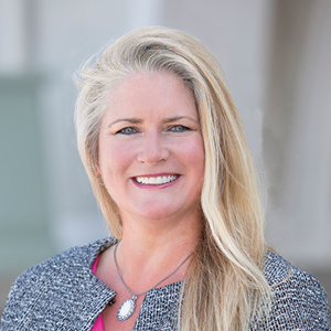 Woman with suit and blonde hair smiling