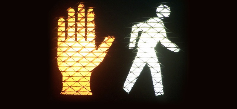 Cross Walk Sign with hand and person walking symbol lit