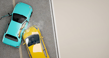 Yellow car crashing into the side of blue car