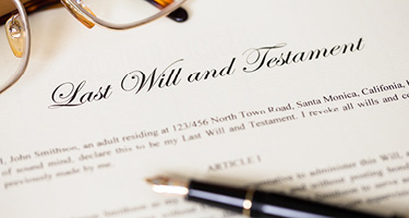 Last will and testament document with pen and glasses