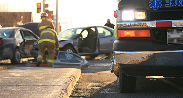 First responders assessing a car accident scene