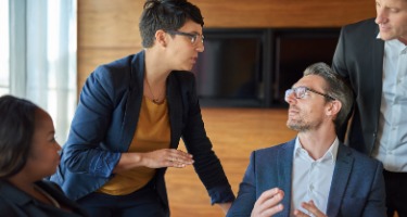 Male and female attorney discuss matters in a boardroom