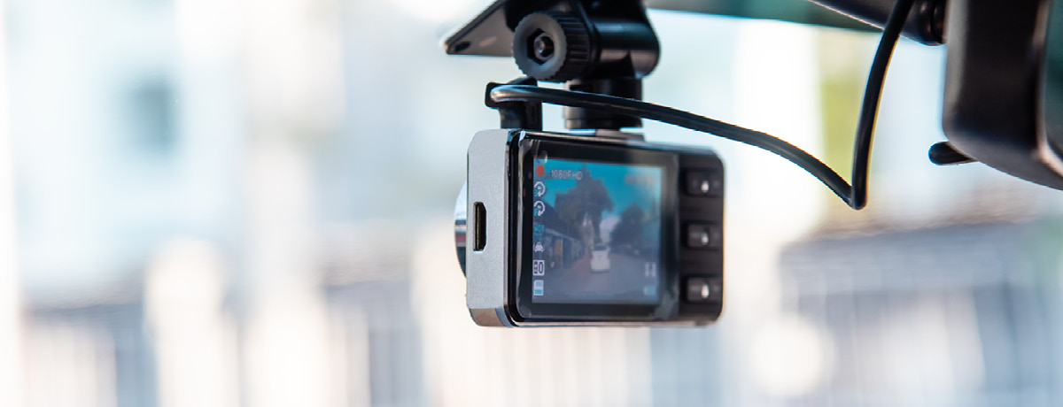 Dashboard camera mounted in a vehicle recording traffic