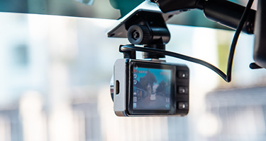 Dashboard camera mounted in a vehicle recording traffic