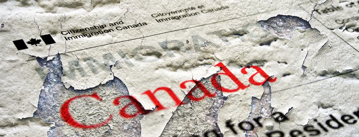 A close-up photograph showing a weathered and peeling document surface.