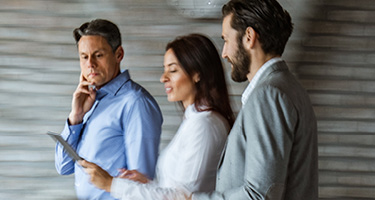 Three professional lawyers walking together and discussing work