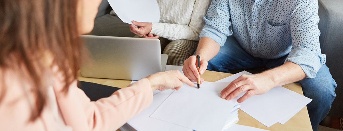 A couple discussing power of attorney paperwork with a lawyer