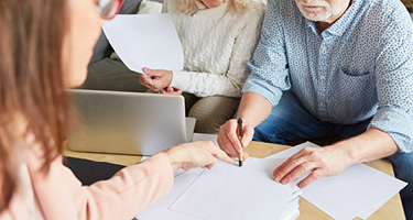 A couple discussing power of attorney paperwork with a lawyer