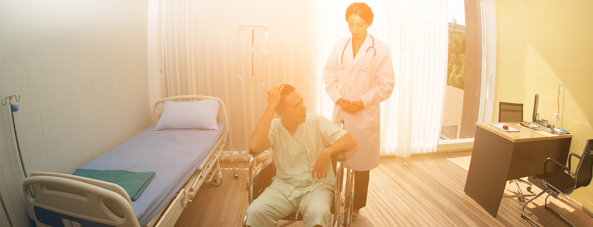A nurse attending to a patient in a hospital room