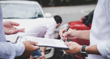 Person Receiving Form at Sight of Car Accident