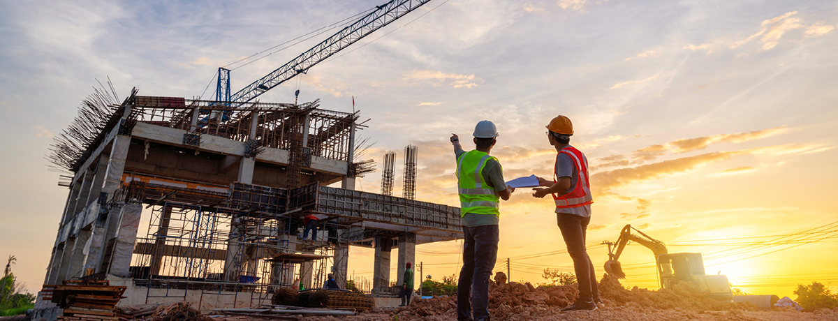 Two construction workers in PPE at construction site