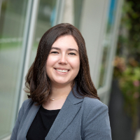 Headshot of female lawyer in grey suit with brown hair