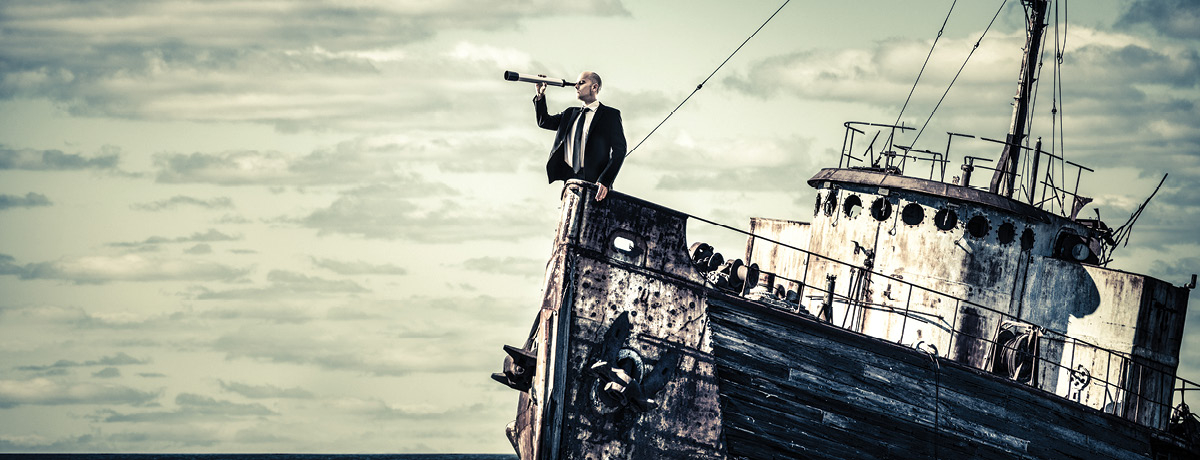 Man in suit with telescope stands on deserted boat