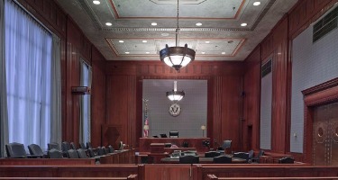 Empty courtroom jury box and seating area.