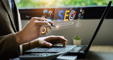 Person working on a laptop with virtual SEO icons, including search targets and analytics symbols