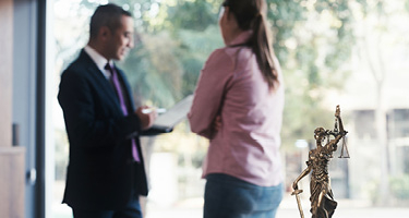 Client consulting with lawyer wearing a suit