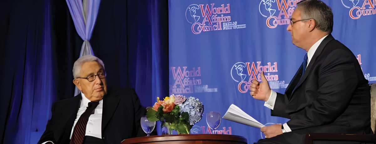 Two men sitting on stage talking
