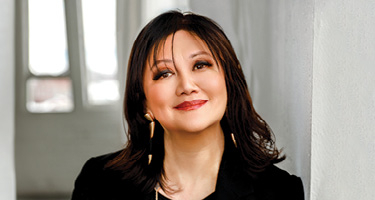 Woman smiles as she poses for lawyer headshot