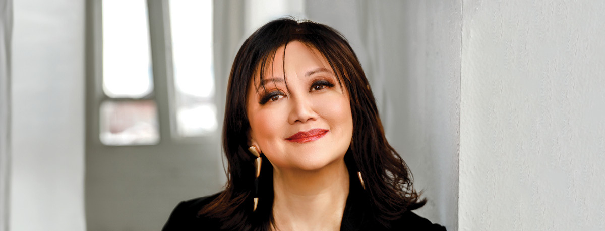 Woman smiles as she poses for lawyer headshot