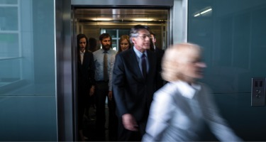 Attorneys walking around a building in a rush