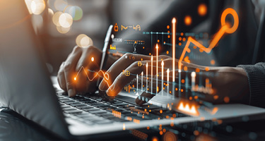 Laptop driving virtual growth with data charts and graphs