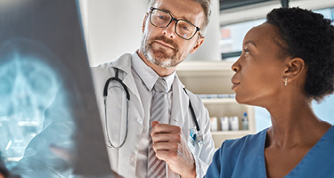 Doctor and nurse discussing X-ray scan