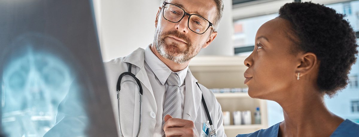 Doctor and nurse discussing X-ray scan