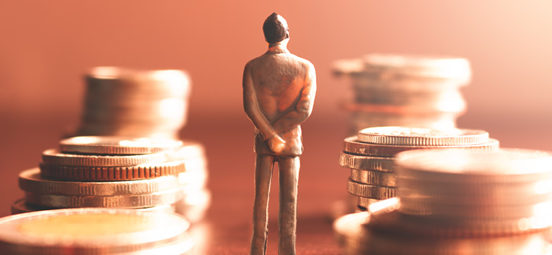 A lone business figure stands between stacks of coins, symbolizing the growing influence of private 