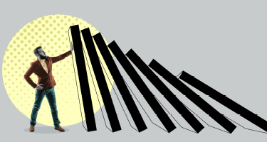 Suited man holding up falling walls with gray and yellow backdrop