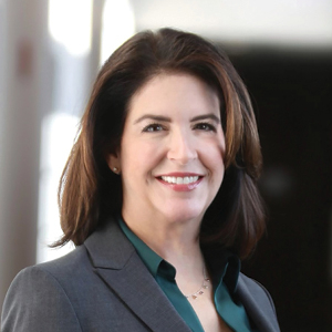 Lawyer in suit with dark hair smiling for headshot