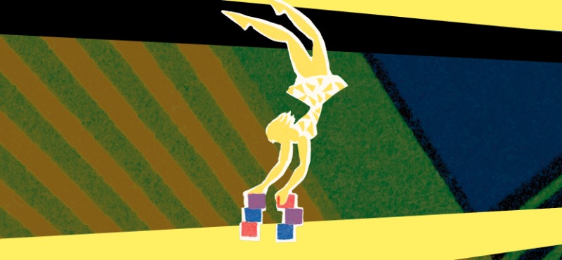 Woman doing a handstand on multiple multicolored blocks on a yellow road