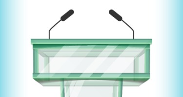 A green debate podium with two microphones with a light blue background