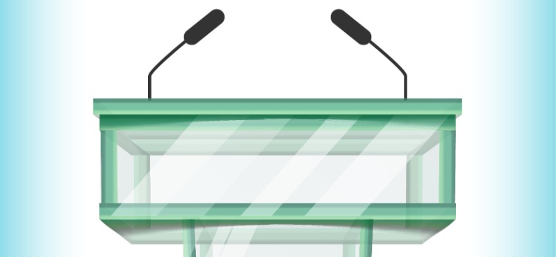 A green debate podium with two microphones with a light blue background
