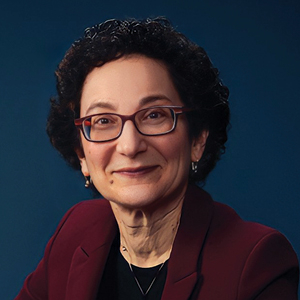 Woman in red suit with dark blue background