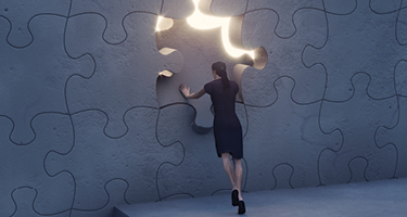 Woman in black dress pushing a glowing puzzle piece