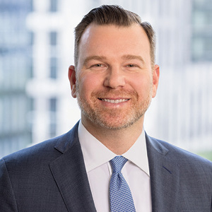 Man in suit and tie smiling for professional headshot