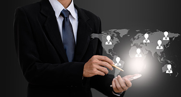 Unseen figure in suit pointing to world map 