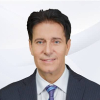 Headshot of man with dark hair in blue suit