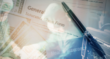 Insurance forms and a pen with doctor in background