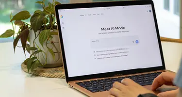 Laptop screen displaying an AI search interface