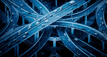 Lots of roads interconnected with cars going in all directions built on infrastructure