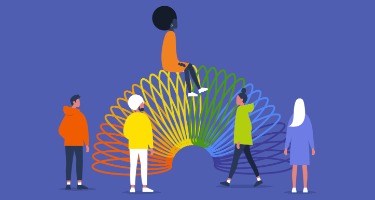 Group of diverse individuals gathered around a colorful rainbow